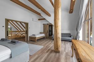 a bedroom with two beds and a wooden table at Chalet Liptov Izipovce in Ižipovce