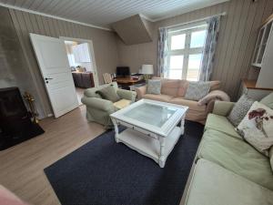 a living room with a couch and a coffee table at Hytte med fin natur in Mork