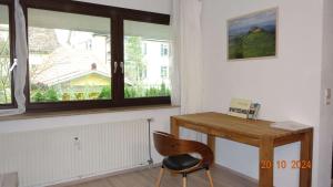 a desk and a chair in a room with a window at Apartment König in Tübingen