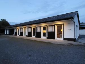 a building with a lot of windows in a parking lot at Orchid Mews in Ballynagore