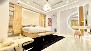 a bedroom with a bed and a large mirror at Bplayluxury in Ogoyo