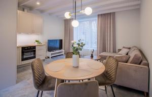 a living room with a table and a couch at Lai Residence Apartment 1 in Tartu