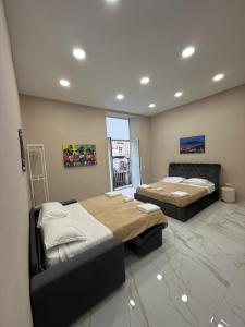 a bedroom with two beds and a fireplace at Valentino caracciolo 105 in Naples