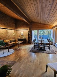 a living room with a table and a couch at Private room - 6 in a luxury villa CHALET STYLE in Oslo