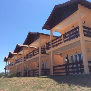 a building with balconies on the side of it at Hotel Fazenda Santa Maria in Serra Negra