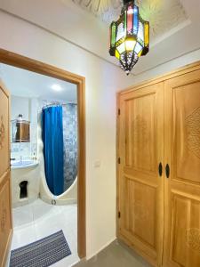 a bathroom with a mirror and a chandelier at Dar Syraya in Chefchaouen +28 photos