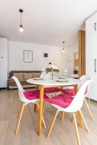 a dining room with a table and chairs at ATENEO - Studio DeLuxe MODERN Apartment, BIG Balcony, Plus FREE Parking in Timişoara