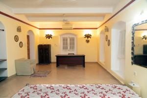 a room with a bed and a desk in it at Zanzibar Vintage House in Stone Town