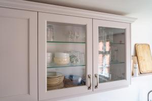 een witte kast met borden en borden erin bij Alandblick Gasthaus in Wanzer +62 foto's