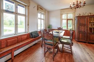 a dining room with a table and chairs and windows at Alandblick Gasthaus in Wanzer