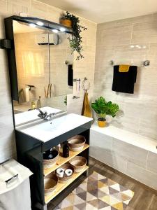 a bathroom with a sink and a bath tub at Gite Les Petits Dragons in Carnoët +36 photos
