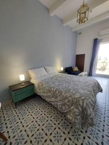 a bedroom with a bed and a table and a window at Studio Suite near Valletta in Il-Furjana +26 photos