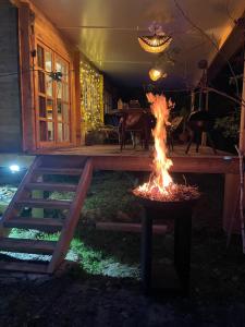 a fire pit in the backyard of a house at Cabane Coco bohème in Azereix