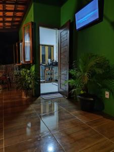 a green room with a door and a plant at Flat de Irinha Moreré in Cayru +34 photos