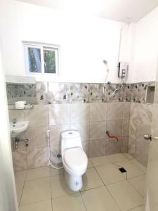 a bathroom with a toilet and a sink at House with Sunrise&Beach view in Candaping B