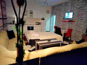 a living room with a bed and a table at Kumalic 2 in Sanski most