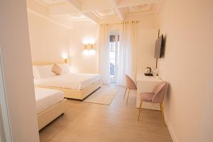 a bedroom with a bed and a desk with a television at Roxy luxury house Rome in Rome