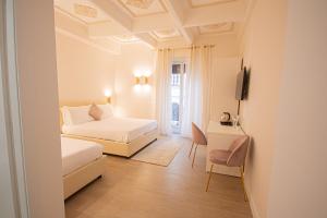 a bedroom with a bed and a desk with a television at Roxy luxury house Rome in Rome