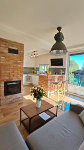 a living room with a couch and a table at Relax Houses - Domy Mazur in Małkinie
