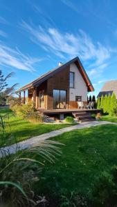 a large house with a grassy yard at Relax Houses - Domy Mazur in Małkinie