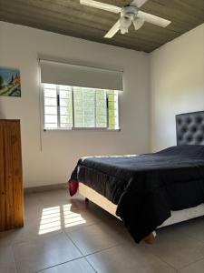 a bedroom with a bed and a window at Los Talares in Baradero