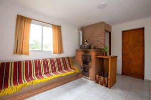 a living room with a couch and a fireplace at Casa, Bosque y Mar in Miramar +6 photos