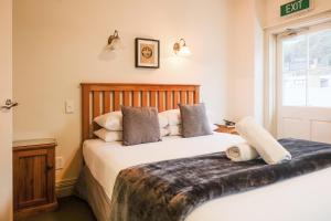 a bedroom with two beds and a window at The Grand Hotel & Bar - Akaroa in Akaroa