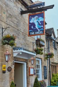 a sign for the angel on the side of a building at The Angel at Burford in Burford