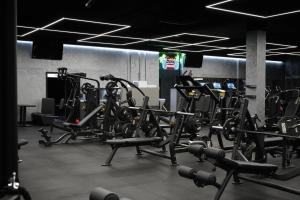 a gym with lots of cardio equipment in it at Apartmán Manhattan s terasou v centre mesta in Trenčín