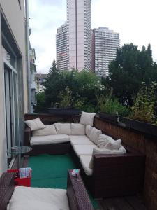 a patio with two couches on a balcony at Zimmer in weißhausstraße in einer Wohnung in Cologne