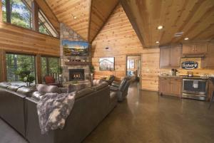 a living room with a couch and a fireplace at NewListing! 1-Mile Choctaw Landing, GameRoom, 6BR, Sleep-18, PET Friendly, HotTub, Play Structure, Smart TV, FirePit, Outdoor in Stephens Gap
