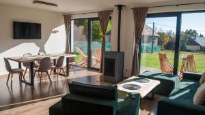 a living room with a couch and a table and chairs at Florián in Vyšné Hágy