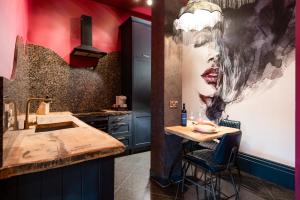 a kitchen with a sink and a counter with a table at The Saafe luxury apartments in Berwick-Upon-Tweed +37 photos