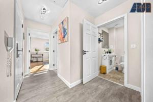 a hallway with a bathroom with a toilet and a sink at Elegant 2Bed Sleeps 4 With Parking in Paisley