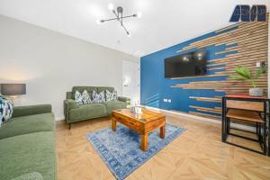 a living room with a couch and a table at Elegant 2Bed Sleeps 4 With Parking in Paisley