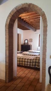 a bedroom with an archway with a bed in it at Podere Il Cerrone app Romilda con piscina in Fauglia +56 photos