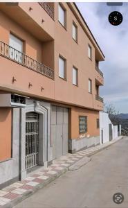 a building with a gate in front of it at Apartamento El Mirador de Sierra Mágina II Noalejo entre Granada y Jaén in Noalejo