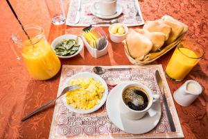 a table with a breakfast of eggs and a cup of coffee at Los Portales de Chivay Hotel in Chivay