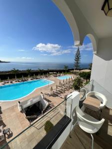 a view of the pool and the ocean from a building at Cura Sea View Apartment in Playa del Cura