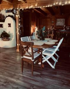 a table and chairs in a kitchen with lights at Mediterrán Vendégház in Zebegény