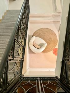 a spiral staircase with a sombrero and a hat at Cà Bèla - Mercadante in Milan