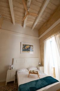 a bedroom with a bed with a table on it at Blue House 9 Rooms & Breakfast in Birgu