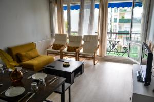 a living room with a couch and chairs and a table at Daz house in Sevran