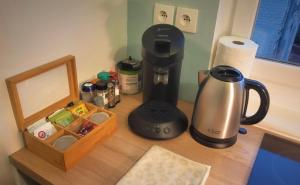a counter with a coffee maker and a box on it at Le Coquet in Saint-Omer