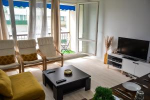 a living room with a couch and a tv at Daz house in Sevran