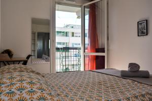 a bedroom with a bed and a large window at Daz house in Sevran