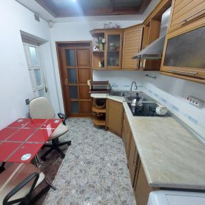 a kitchen with a sink and a red counter top at Karabakh boutigue-Hostel-apartment in Baku