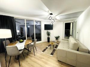 a living room with a couch and a table at Skyview Sunlight Apartment 29th Floor in Skopje
