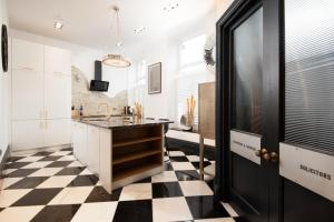 a kitchen with a black and white checkered floor at The Vault Luxury Apartment in Berwick-Upon-Tweed