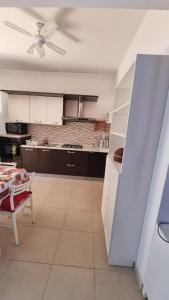 a kitchen with a table and a ceiling fan at La Dea Busa in Canosa di Puglia